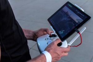 Man using controls of drone